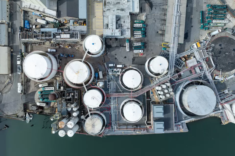 Bird's eye view of water treatment plant next to water body.